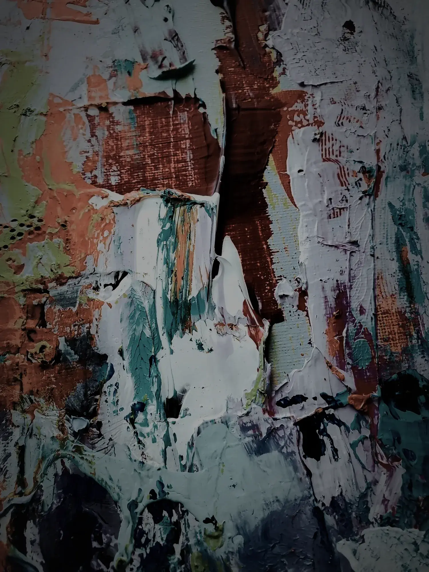 Thick layers of paint in white, rust and teal, built up over time